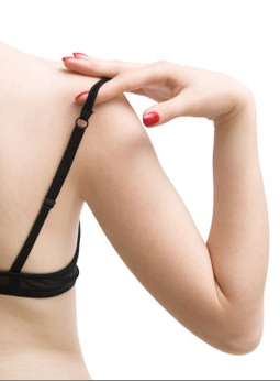 A woman's upper body, with a bra strap falling off her shoulder